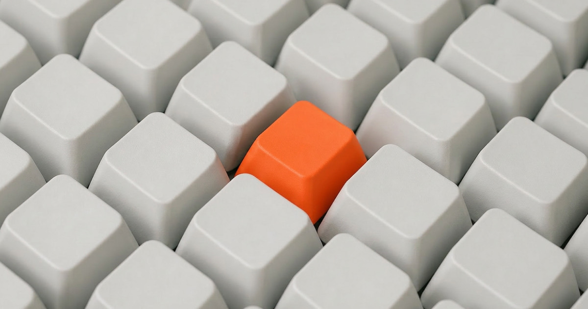 A single orange keycap standing out in a grid of identical white keycaps, representing AI governance bringing order to scattered AI experiments